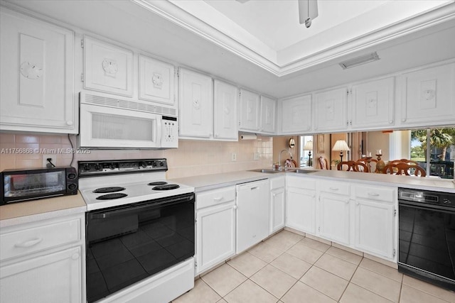 kitchen with white appliances and white cabinetry