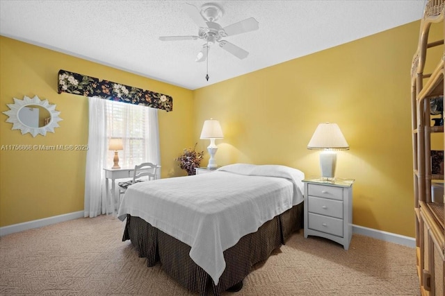 bedroom with light carpet, a textured ceiling, a ceiling fan, and baseboards