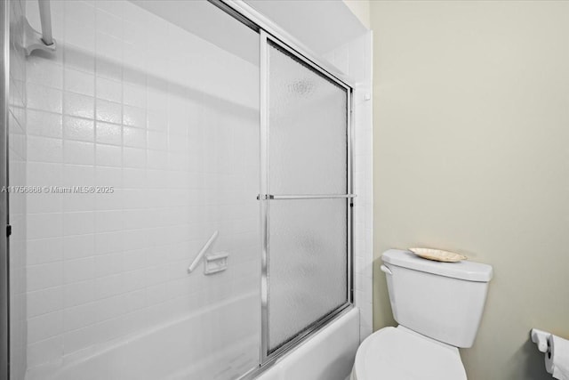 bathroom with shower / bath combination with glass door and toilet