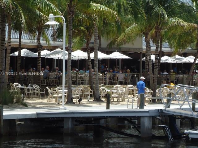 view of home's community featuring a dock and a water view