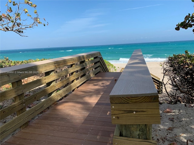 exterior space with a water view and a beach view