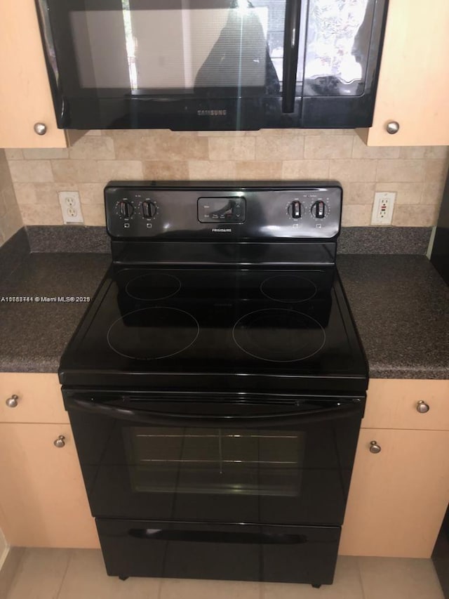 kitchen featuring dark countertops, black electric range oven, decorative backsplash, and light tile patterned floors