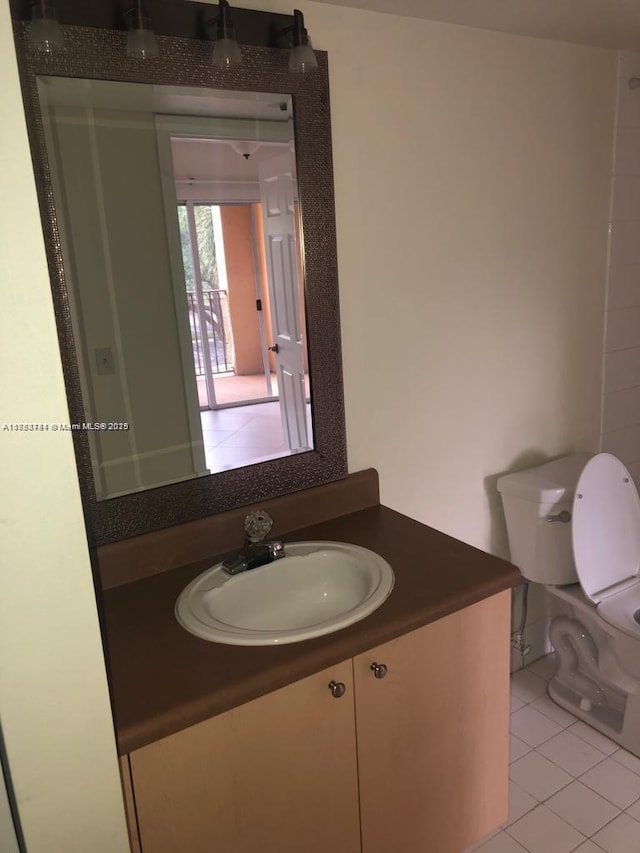 half bathroom featuring toilet, tile patterned flooring, and vanity