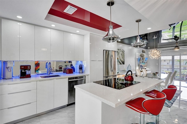 kitchen with modern cabinets, white cabinetry, dishwasher, and freestanding refrigerator