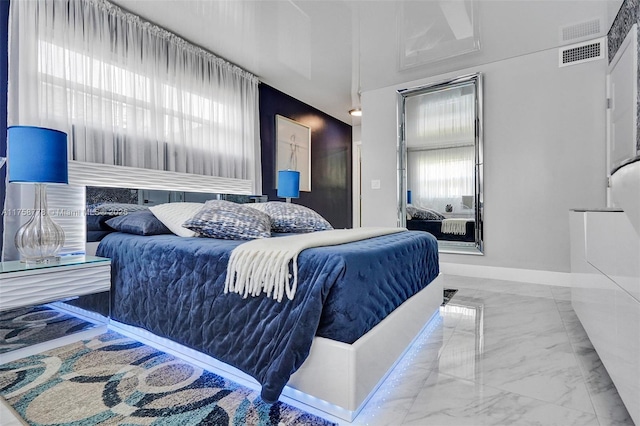 bedroom featuring marble finish floor, visible vents, and baseboards