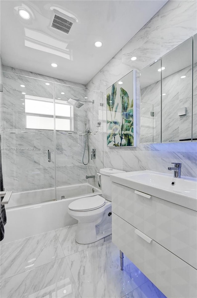 full bath with toilet, shower / bath combination with glass door, visible vents, tile walls, and marble finish floor