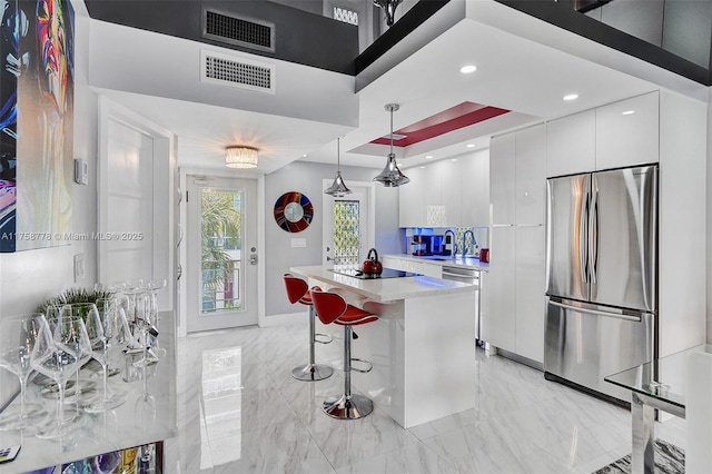 kitchen with white cabinetry, visible vents, modern cabinets, and appliances with stainless steel finishes