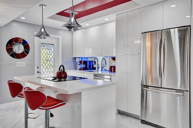 kitchen featuring marble finish floor, stainless steel appliances, modern cabinets, and white cabinetry