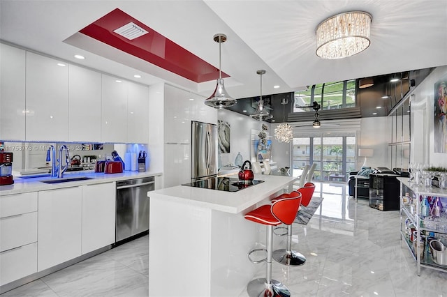 kitchen with white cabinets, modern cabinets, stainless steel appliances, and a sink