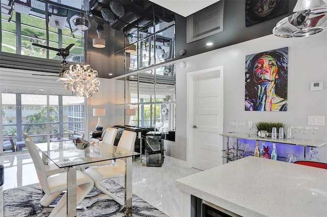 dining area with marble finish floor, baseboards, and a notable chandelier