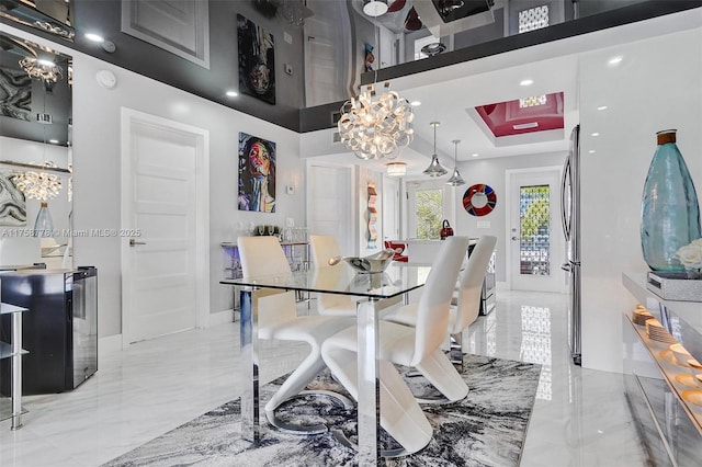 dining room with marble finish floor, recessed lighting, a raised ceiling, and baseboards