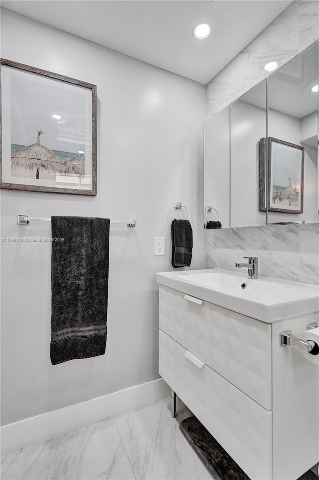 bathroom featuring recessed lighting, marble finish floor, vanity, and baseboards