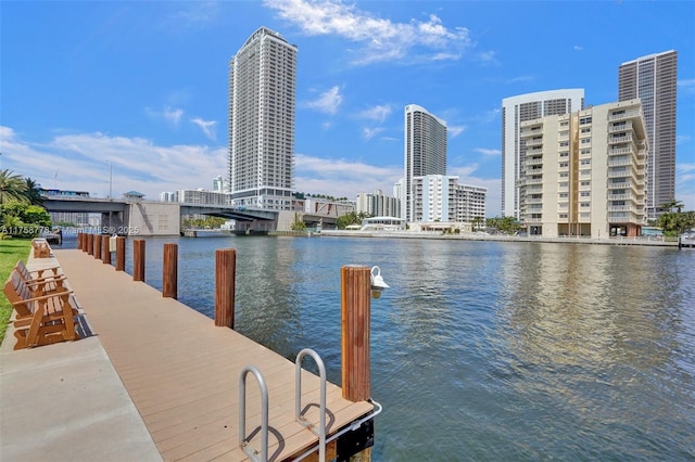 dock area featuring a water view and a city view