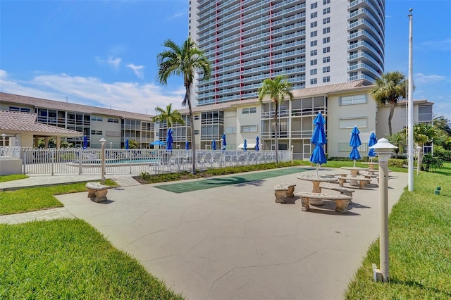 view of community with a pool and fence