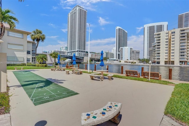 view of property's community with shuffleboard, a water view, and a city view