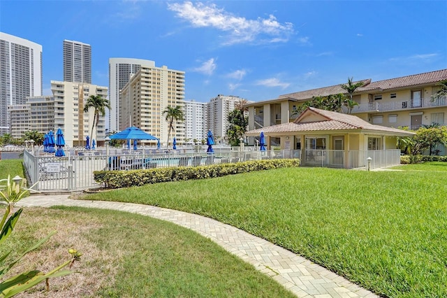 view of property's community with a yard and fence