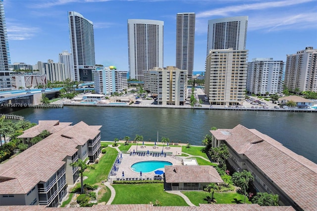 birds eye view of property with a view of city and a water view