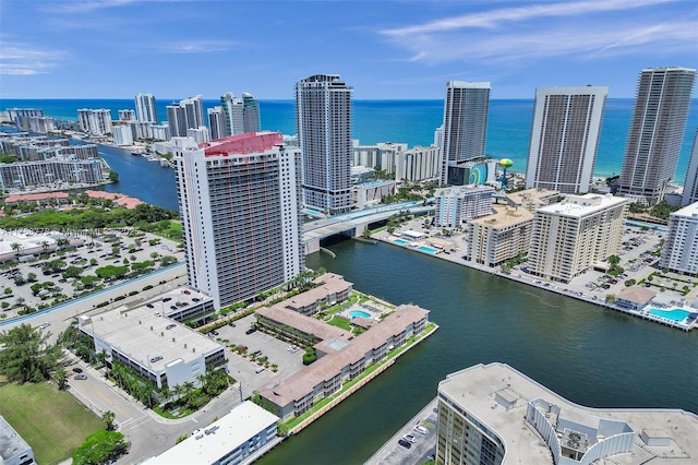 birds eye view of property featuring a water view and a city view