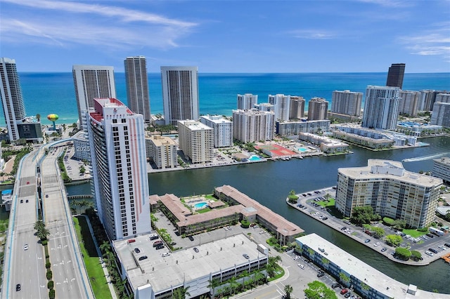 drone / aerial view featuring a view of city and a water view