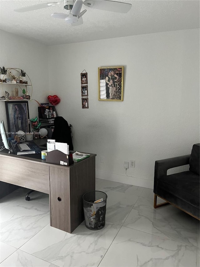 office featuring marble finish floor, a textured ceiling, baseboards, and a ceiling fan