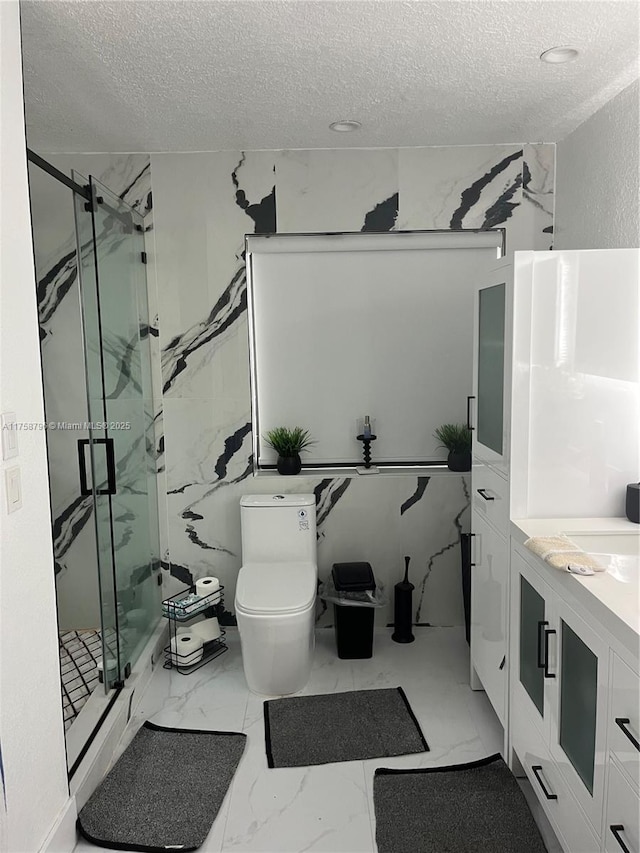 full bathroom with toilet, marble finish floor, a marble finish shower, and a textured ceiling