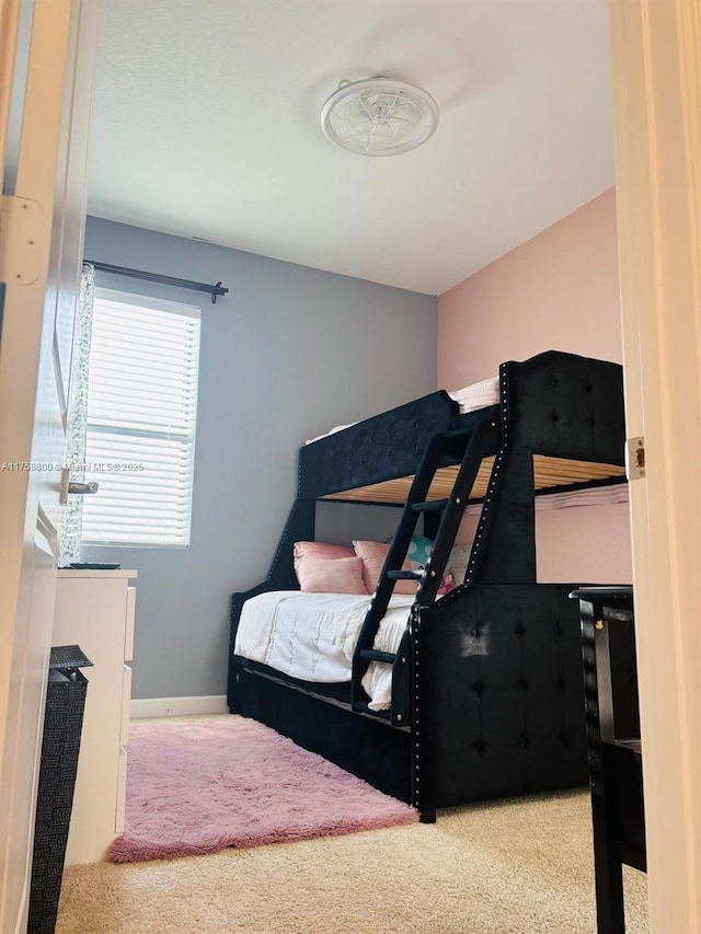 carpeted bedroom featuring baseboards