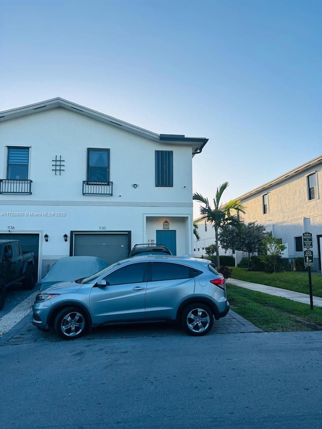 view of front of property with an attached garage and stucco siding