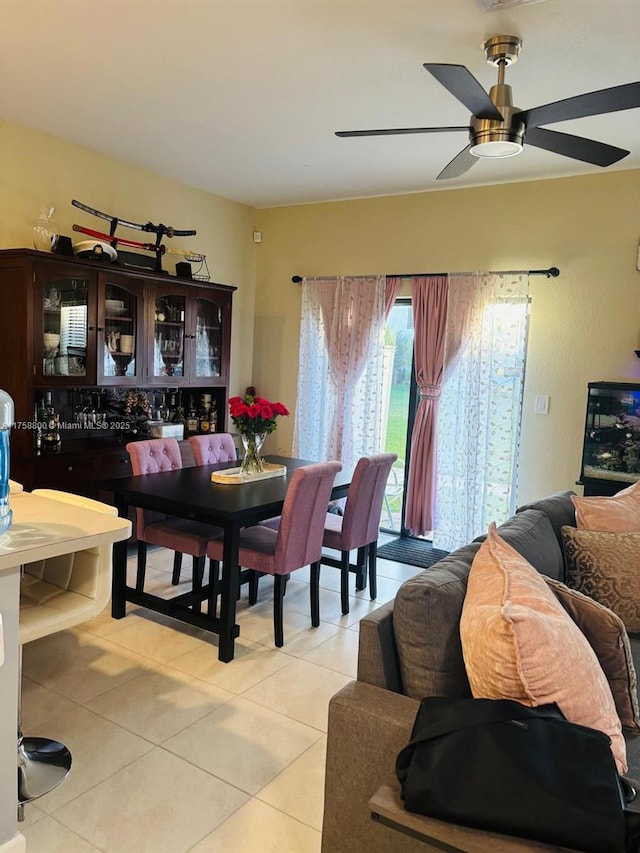 dining room with light tile patterned floors and a ceiling fan