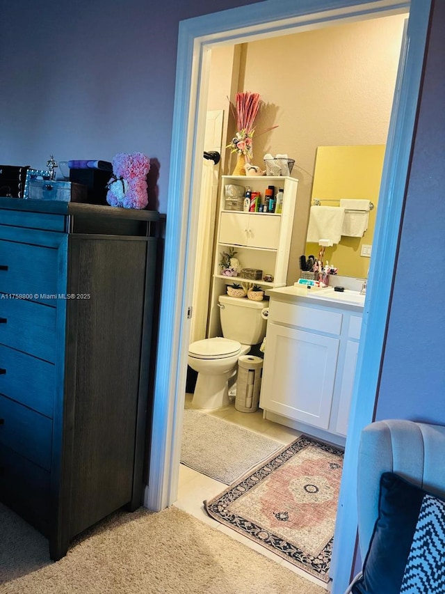 bathroom featuring vanity and toilet