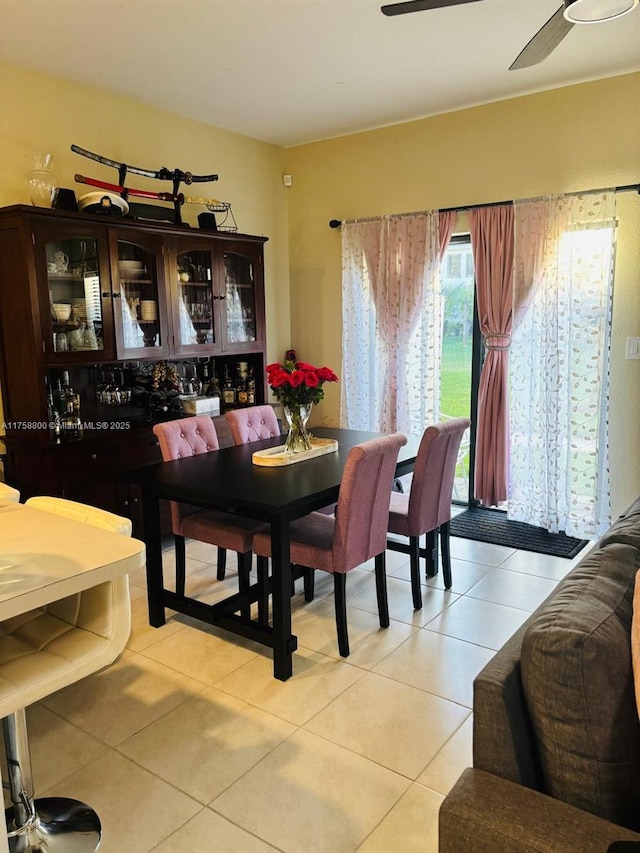 dining area with light tile patterned flooring and a ceiling fan