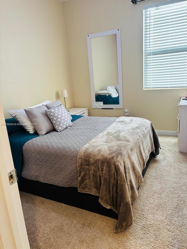 bedroom featuring carpet floors and baseboards