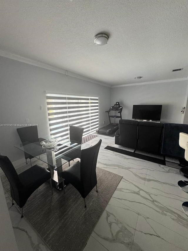 dining room featuring marble look tiles, ornamental molding, and a textured ceiling