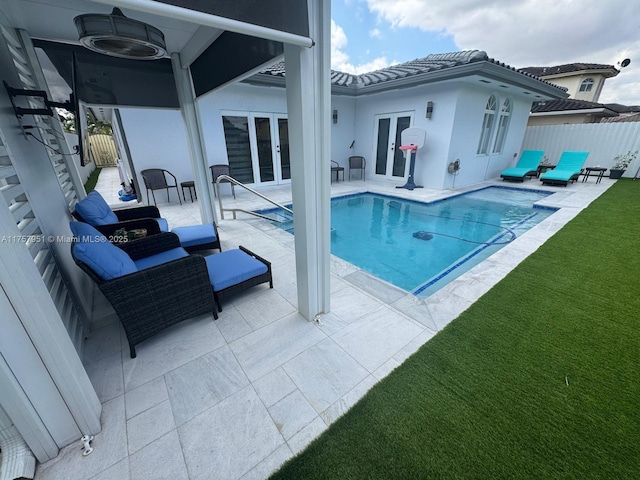 view of pool featuring french doors, fence, a fenced in pool, and a patio area