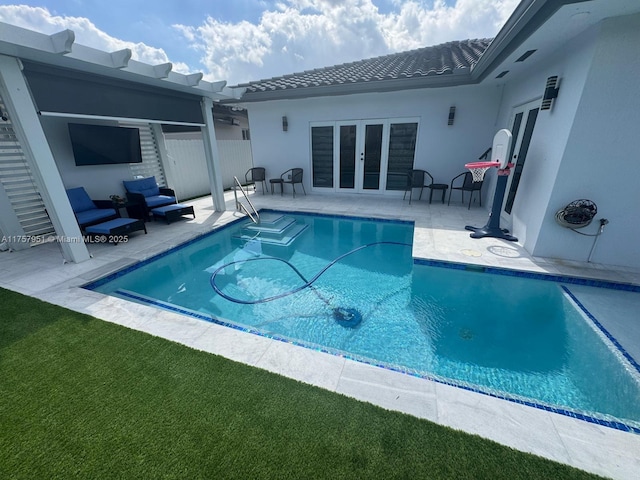 view of pool featuring french doors, a patio area, and fence
