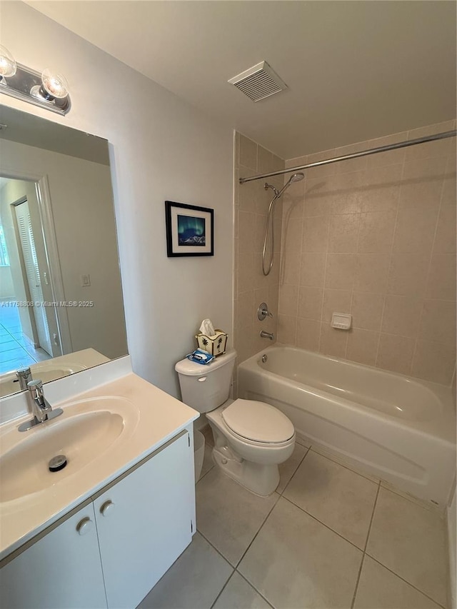 bathroom with shower / washtub combination, visible vents, toilet, vanity, and tile patterned flooring