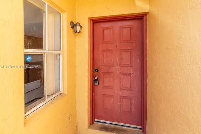 entrance to property with stucco siding