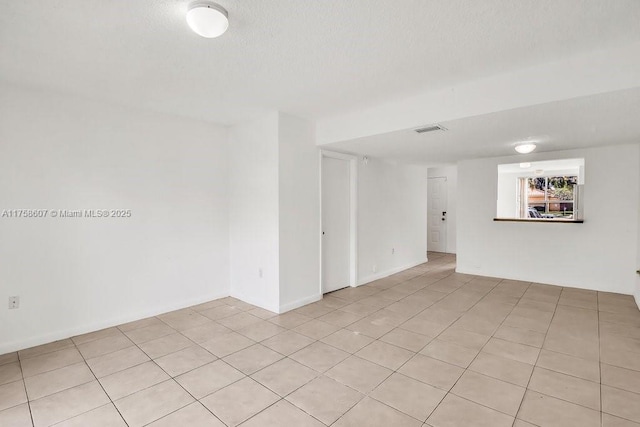 unfurnished room with a textured ceiling and visible vents