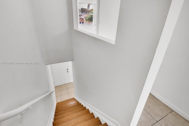 staircase with tile patterned flooring and baseboards