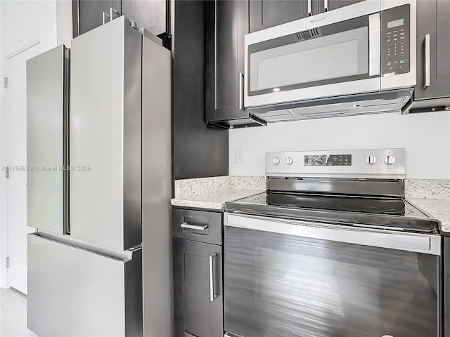 kitchen featuring light stone counters and appliances with stainless steel finishes