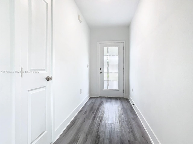 entryway featuring baseboards and dark wood-style flooring