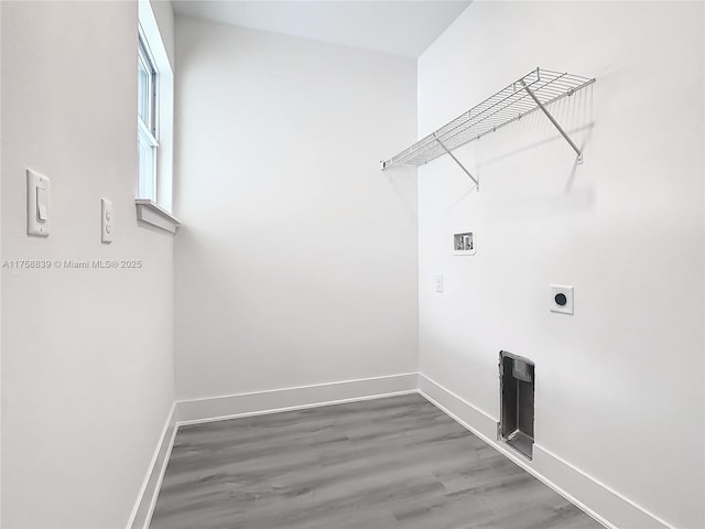 laundry room featuring electric dryer hookup, baseboards, hookup for a washing machine, and laundry area