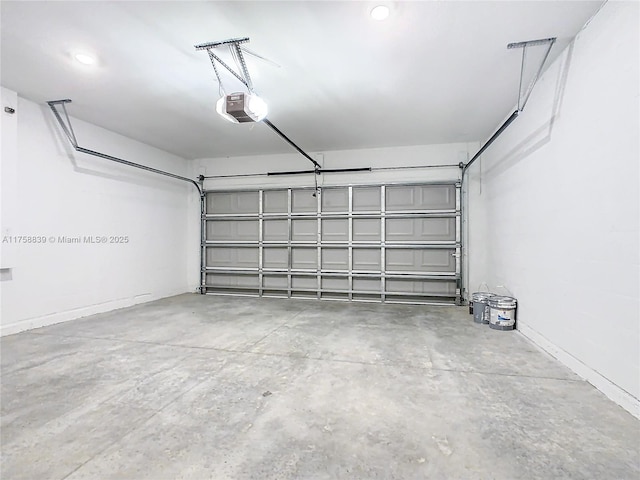 garage featuring a garage door opener and baseboards