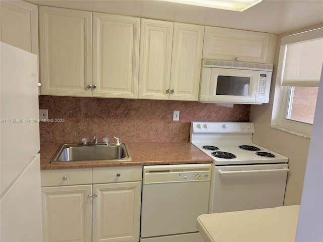 kitchen featuring white appliances, a sink, and tasteful backsplash