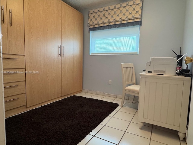 unfurnished bedroom featuring light tile patterned flooring and a textured ceiling