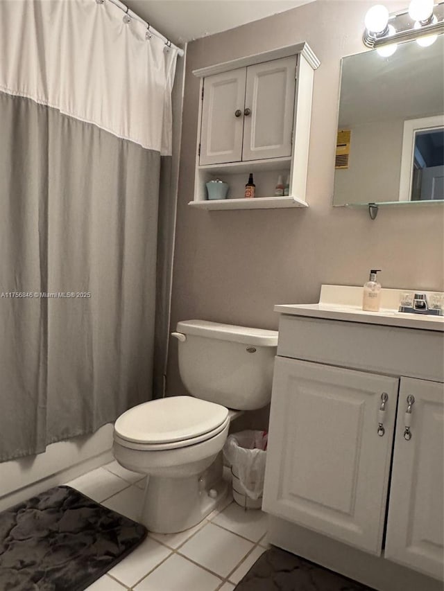 full bath featuring vanity, toilet, and tile patterned floors