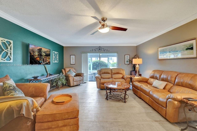 living area with light wood-style flooring, a textured ceiling, ornamental molding, and a ceiling fan