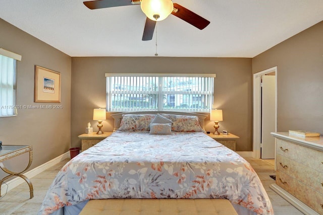 bedroom featuring a ceiling fan and baseboards