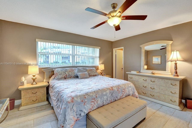 bedroom featuring ceiling fan and baseboards