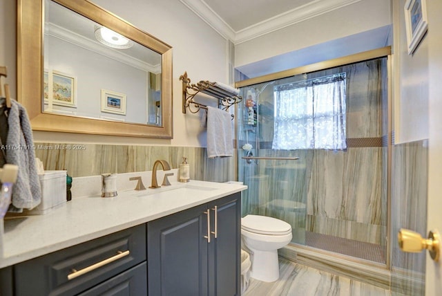 bathroom featuring toilet, a wainscoted wall, crown molding, vanity, and a shower stall