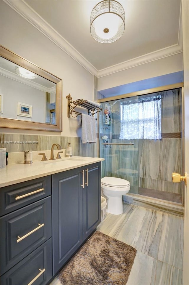 full bath featuring toilet, tile walls, vanity, a stall shower, and crown molding